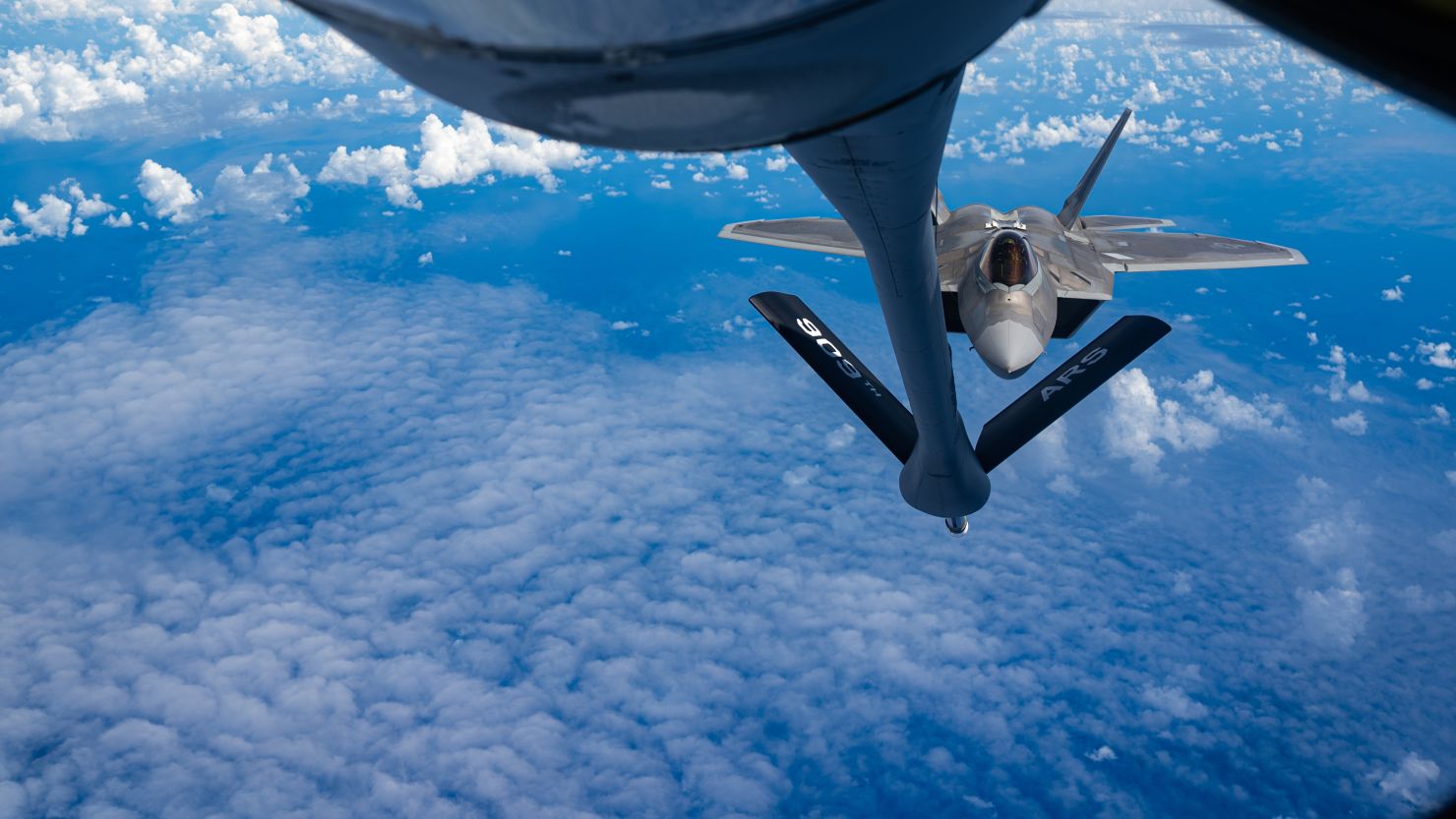 A US Air Force F-22A Raptor fighter jet approaches a KC-135 Stratotanker to refuel over the East China Sea on June 8, 2022. 