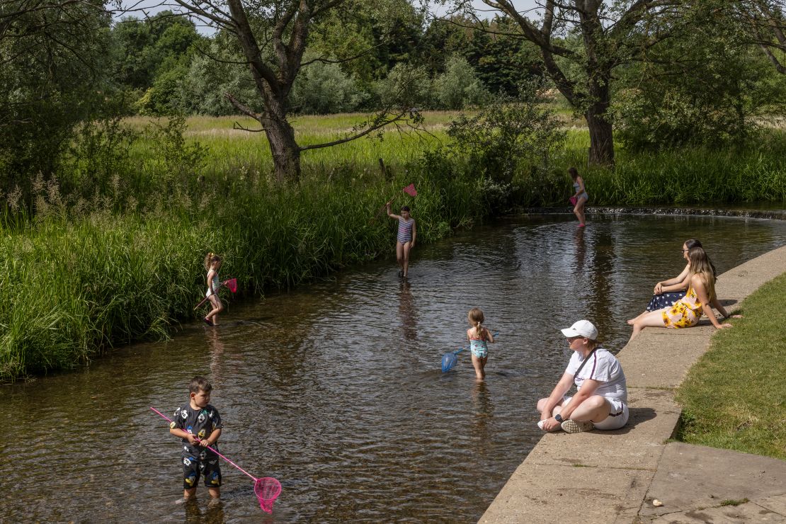 Families cool off in the River Darent on July 12 in Eynsford, UK. 