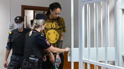 US WNBA basketball superstar Brittney Griner enters a defendants' cage before a hearing at the Khimki Court in the town of Khimki outside Moscow on July 15, 2022. - Griner, a two-time Olympic gold medallist and WNBA champion, was detained at Moscow airport in February on charges of carrying in her luggage vape cartridges with cannabis oil, which could carry a 10-year prison sentence. (Photo by NATALIA KOLESNIKOVA / AFP) (Photo by NATALIA KOLESNIKOVA/AFP via Getty Images)