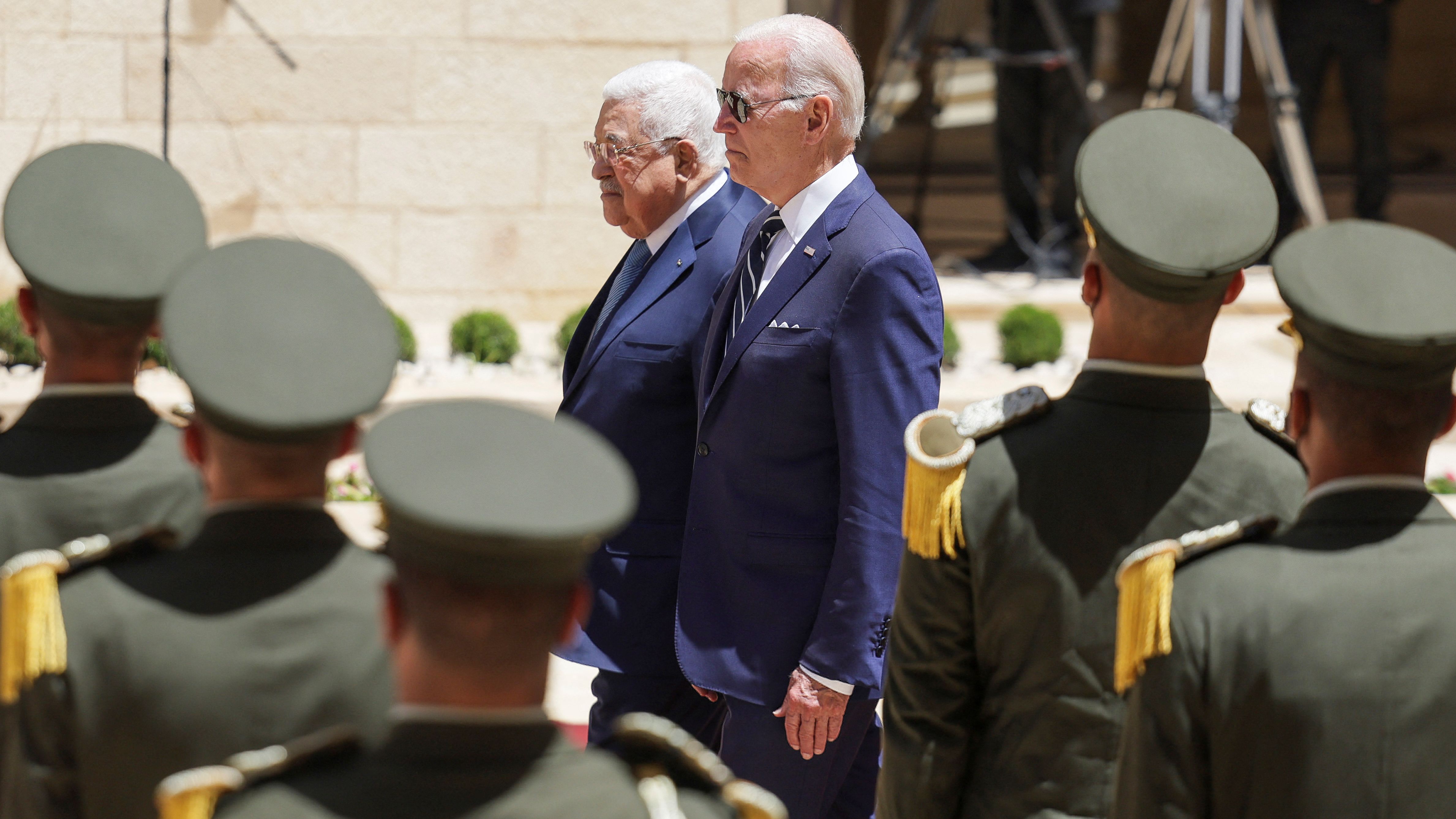 Biden and Palestinian President Mahmoud Abbas walk together Friday at the Presidential Compound in the West Bank.