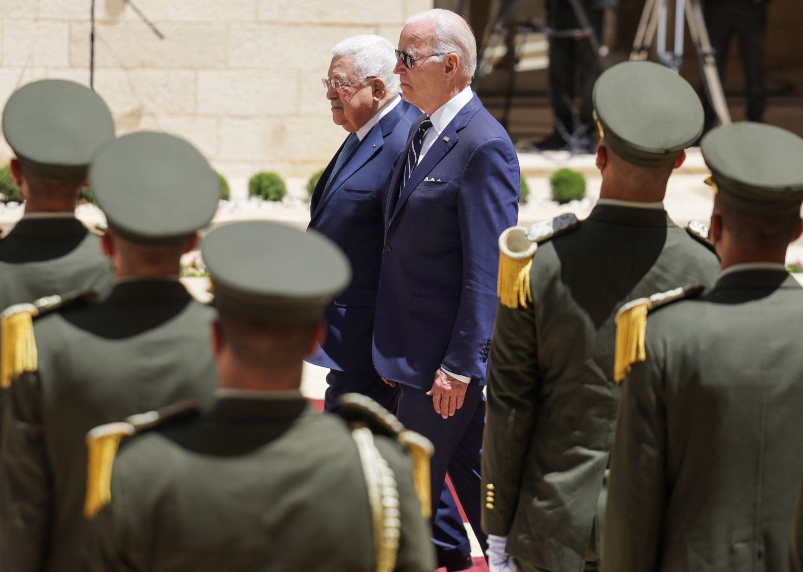 Biden and Palestinian President Mahmoud Abbas walk together Friday at the Presidential Compound in the West Bank.