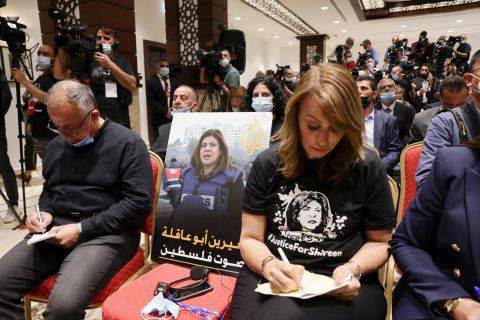 An image of Palestinian-American journalist Shireen Abu Akleh, who was fatally shot while covering an Israeli military operation in the West Bank, is seen on a chair at a news conference with Biden and Abbas. Biden said her death was "an enormous loss to the essential work of sharing with the world the story of the Palestinian people."