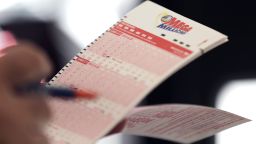 A man fills out a lottery ticket for the Mega Millions jackpot in New York City on October 19, 2018.