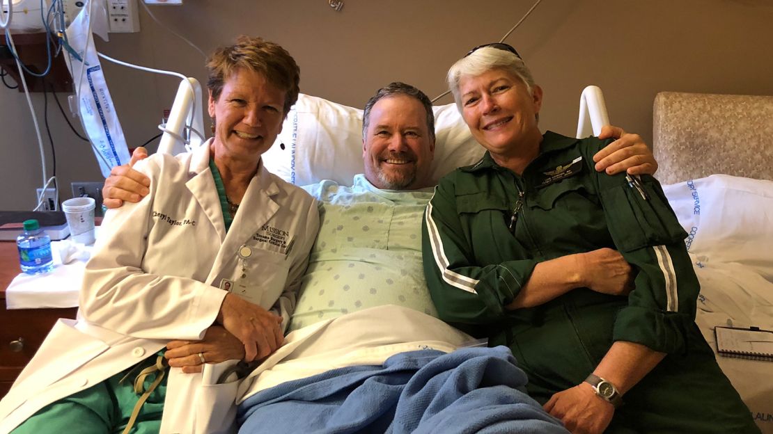 Scott Vuncannon (center) is pictured near the end of his 14-day recovery at Mission Hospital in Asheville, North Carolina.  Here, he's with Cheryl Taylor (left), one of his trauma care physician assistants, and Lois Hancock, a flight medic who intubated him to keep him alive while en route to the hospital.