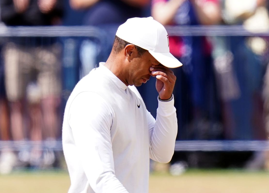 Woods wipes his eyes on his way over the 18th fairway.