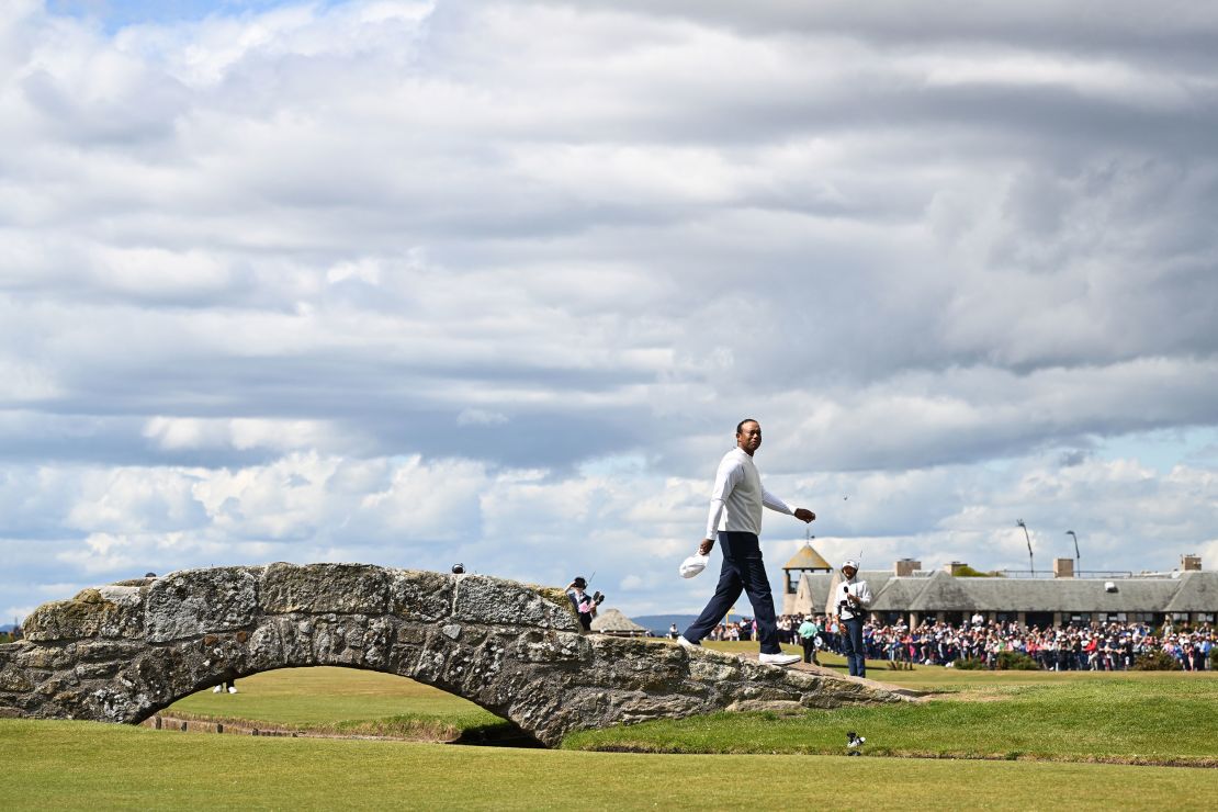 Woods acknowledges the crowd on the Swilcan Bridge.