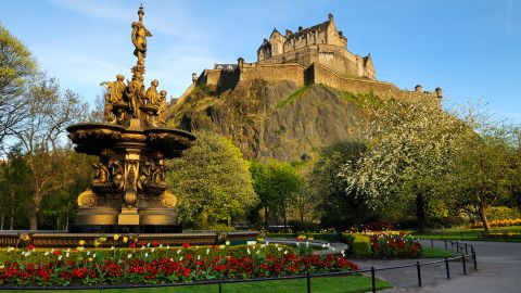 A view of the iconic Edinburgh Castle, looking up from Princess Street gardens with the Ross fountain in the foreground. XL image size.
