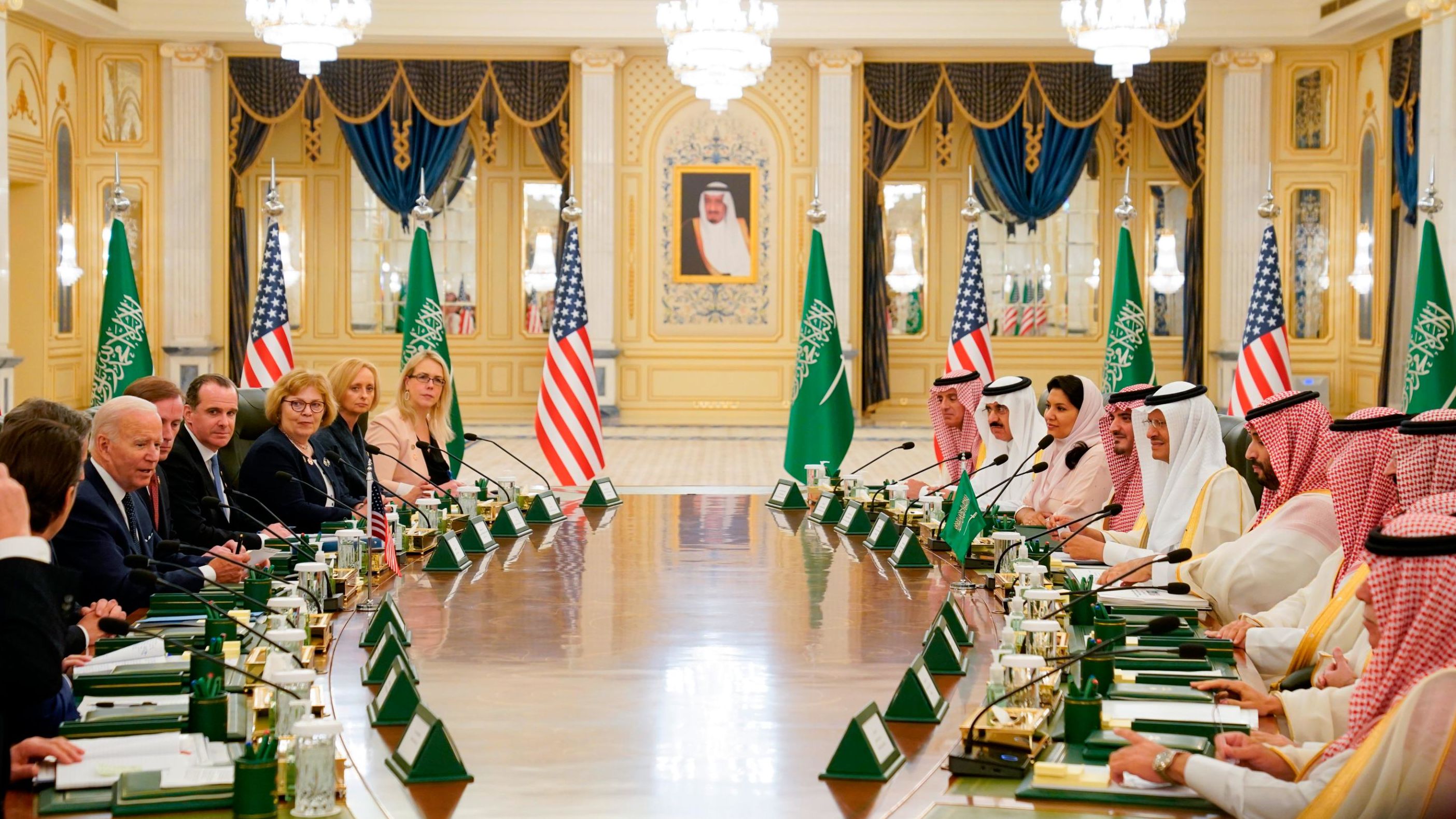 Biden and his delegation, left, sit down with the Crown Prince and his team for talks at the palace.