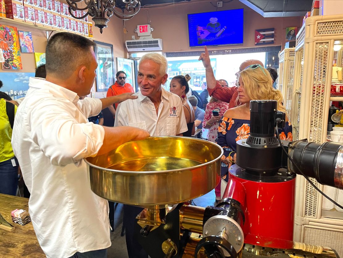 Crist and his fiancée, Chelsea Grimes, watch as coffee beans are roasted at La Colada Gourmet in Little Havana in Miami on July, 9, 2022. 
