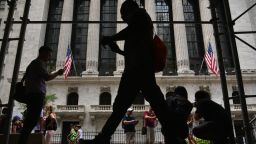 People walk past the New York Stock Exchange (NYSE) on Wall Street on July 14, 2022 in New York.