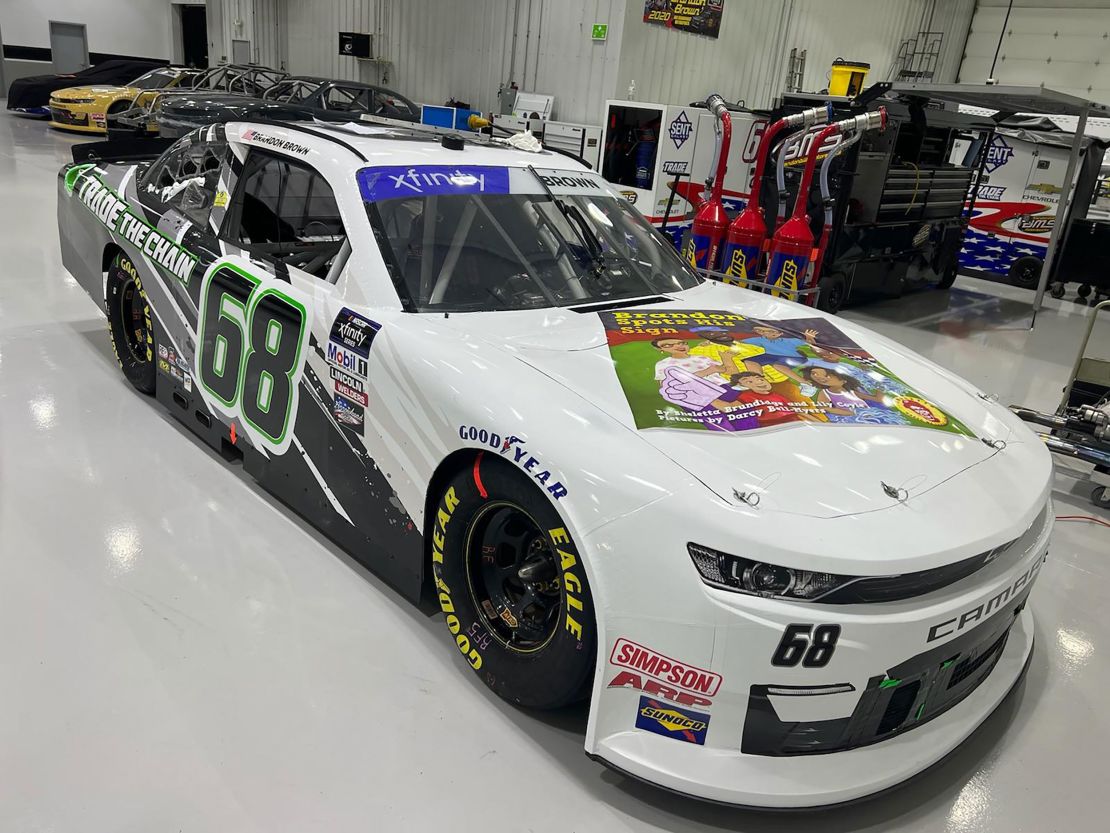 The book's cover adorns the hood of Brown's race car.