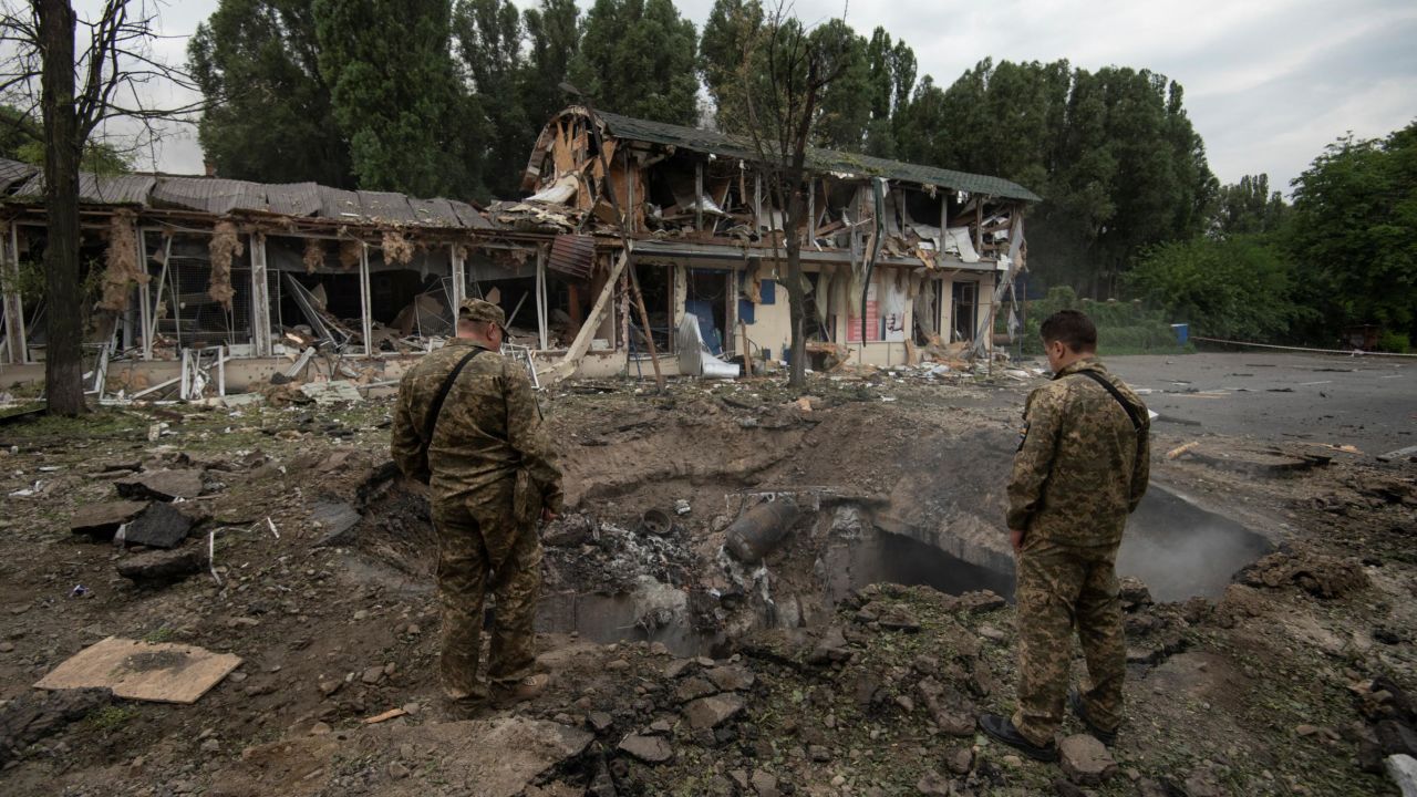 Ukrainian service members inspect a crater left by a Russian missile strike, as Russia's attack on Ukraine continues, in Dnipro, Ukraine July 16, 2022. REUTERS/Mykola Synelnykov