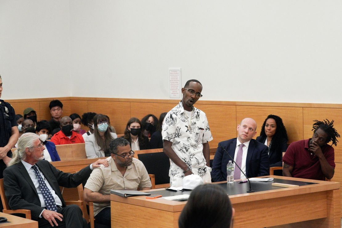 Vincent Ellerbe, center, addresses the court and Thomas Malik, second from left, and James Irons, far right, during a hearing for their exoneration at Brooklyn Supreme Court on July 15, 2022, in New York.