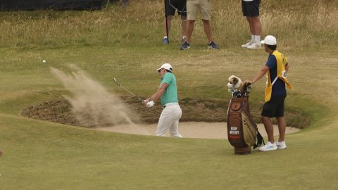 McIlroy holes from the bunker at the 10th for eagle.