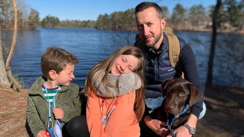 CNN's Adam Charlton with his US-born children and their dog at Georgia's Stone Mountain Lake in 2021. 