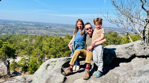 Charlton, with his kids near the top of Stone Mountain, says it's time for his family to return to the UK.
