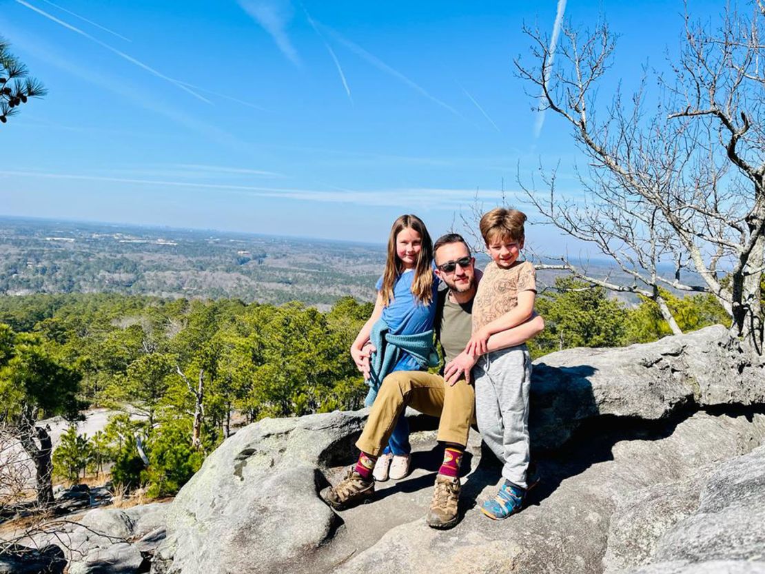 Charlton, with his kids near the top of Stone Mountain, says it's time for his family to return to the UK.