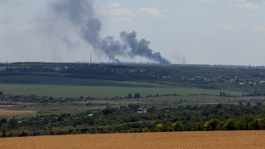 Vuhlehirsk's heat power plant burns in the distance after a shelling, amid Russia's attack on Ukraine, near the town of Svitlodarsk, Donetsk region, Ukraine July 13, 2022.