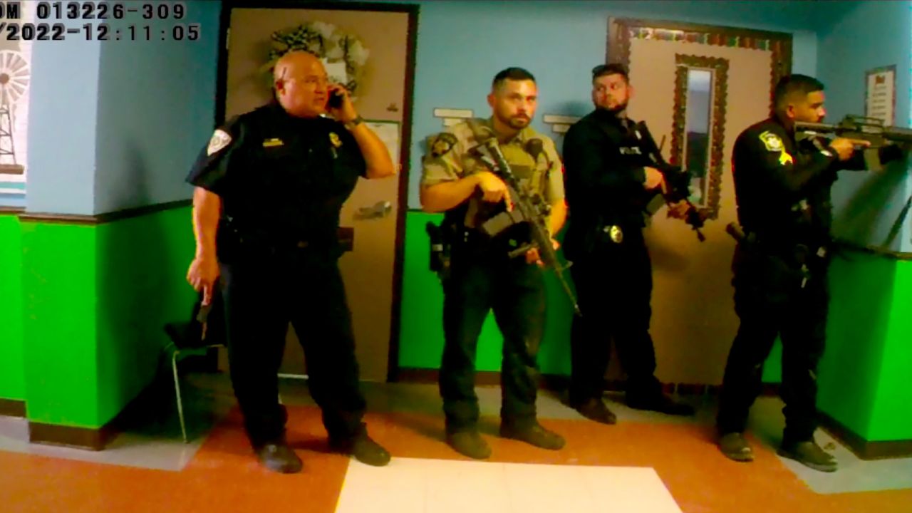 In this still from a video released by Uvalde Mayor Don McLaughlin, Uvalde school police chief Pedro "Pete" Arredondo, left, speaks on his phone in the hallway of Robb Elementary.