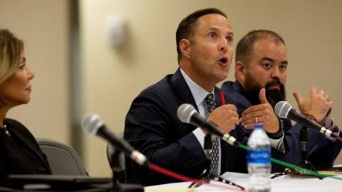Rep. Dustin Burrows, center, speaks with committee members during a press conference after the viewing of the video from inside Robb Elementary School on July 17, 2022.