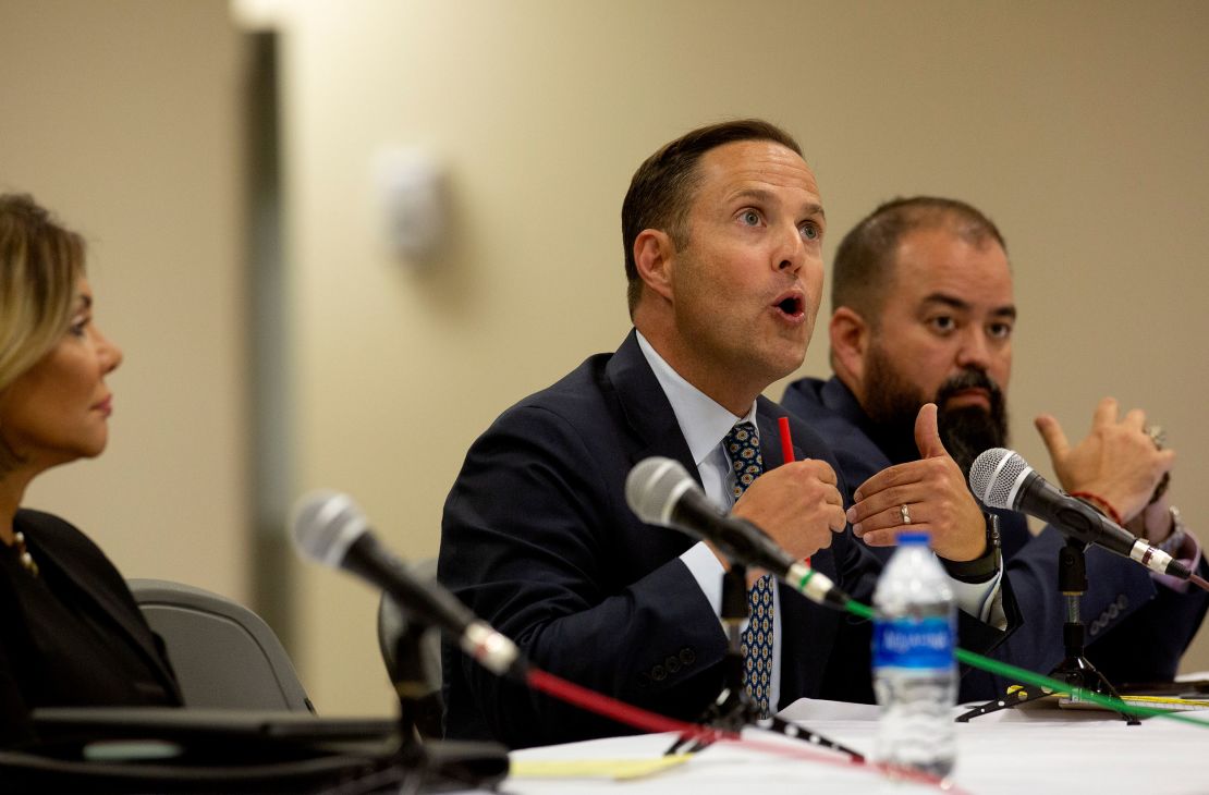 Rep. Dustin Burrows, center, speaks with committee members during a press conference after the viewing of the video from inside Robb Elementary School on July 17, 2022. 