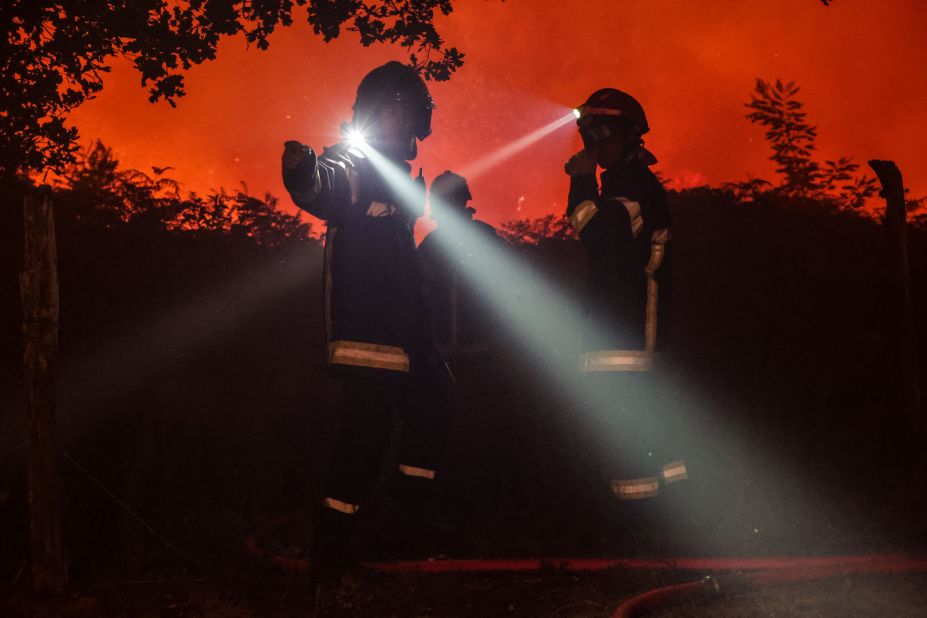 Firefighters attempt to control a fire in the French communes of Landiras and Guillos on July 13.