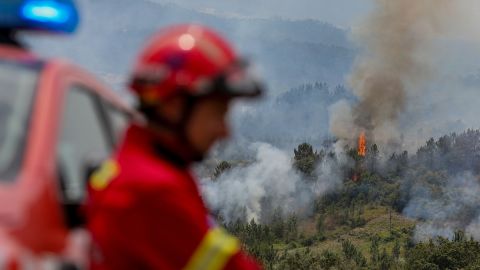 A firefighter looks on during firefighting operations in Espite, Portugal, on July 13.