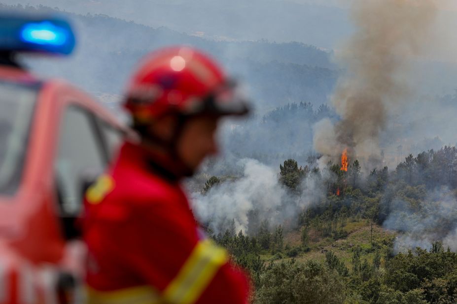 A firefighter looks on during firefighting operations in Espite, Portugal, on July 13.