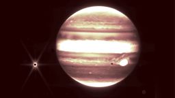 Jupiter, center, and its moon Europa, left, are seen through the James Webb Space Telescope's NIRCam instrument 2.12 micron filter.