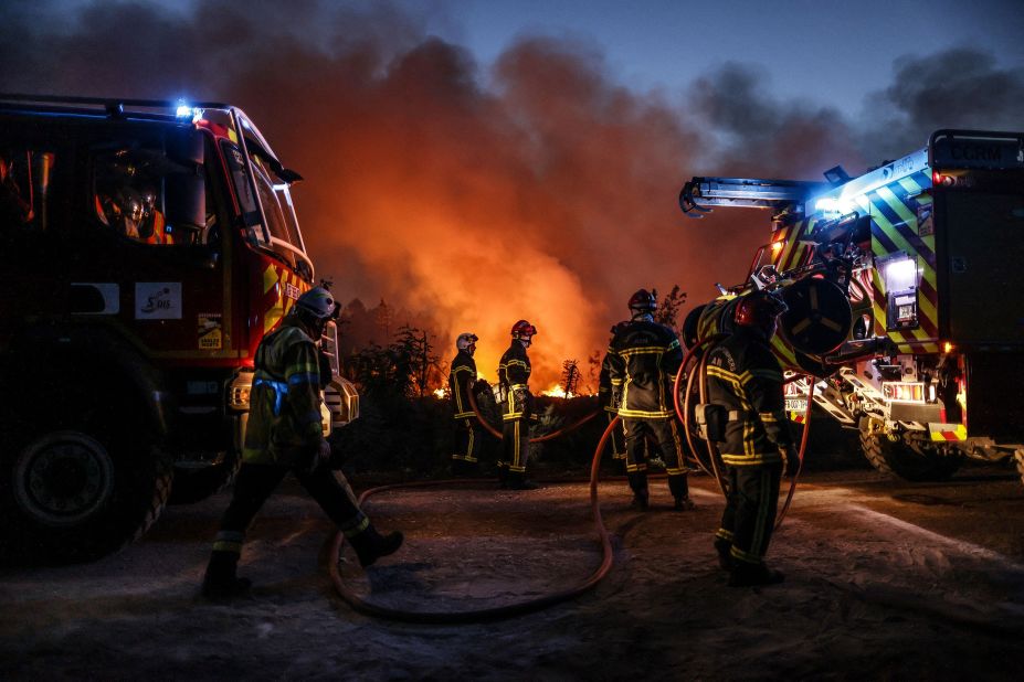 Firefighters try to control a wildfire in Louchats, France, on July 17.