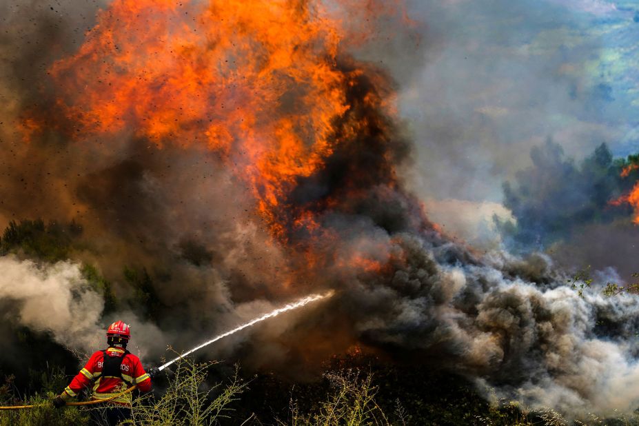 A firefighter tackles the flames surrounding Portugal's Ancede village on July 15.