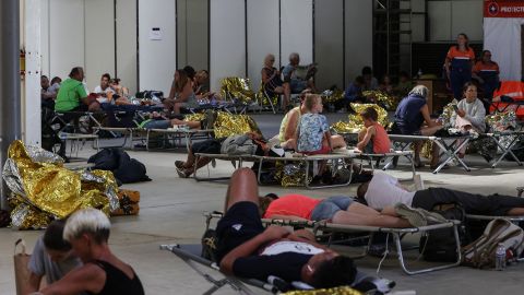 People rest after being evacuated from a campsite in western France on July 13.