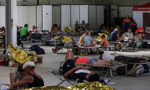 People rest after being evacuated from a campsite in western France on July 13.