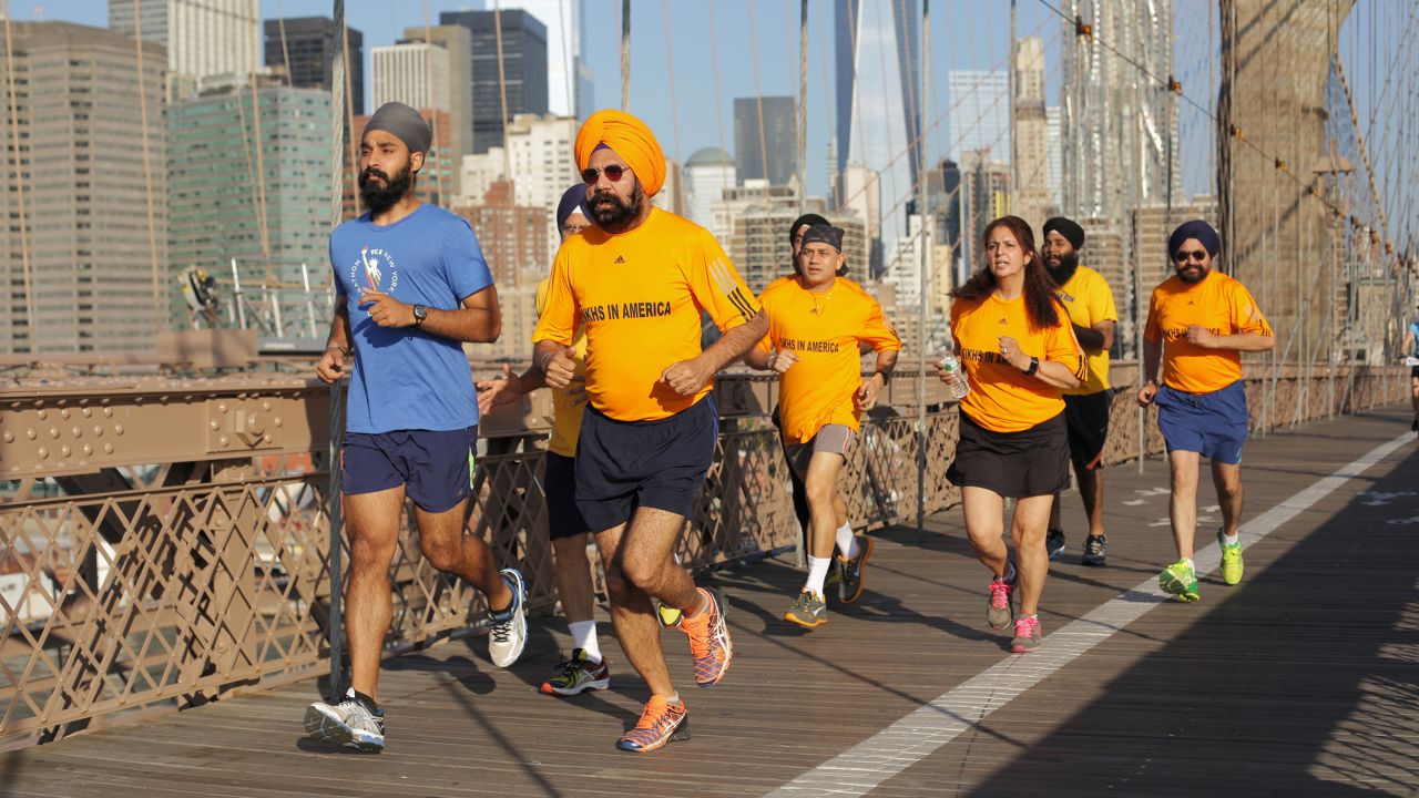 Singh (pictured here in blue) running on the Brooklyn Bridge with Sikhs in the City running club.