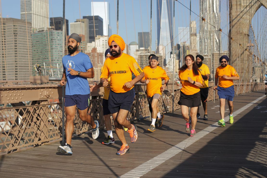 Singh (pictured here in blue) running on the Brooklyn Bridge with Sikhs in the City running club.