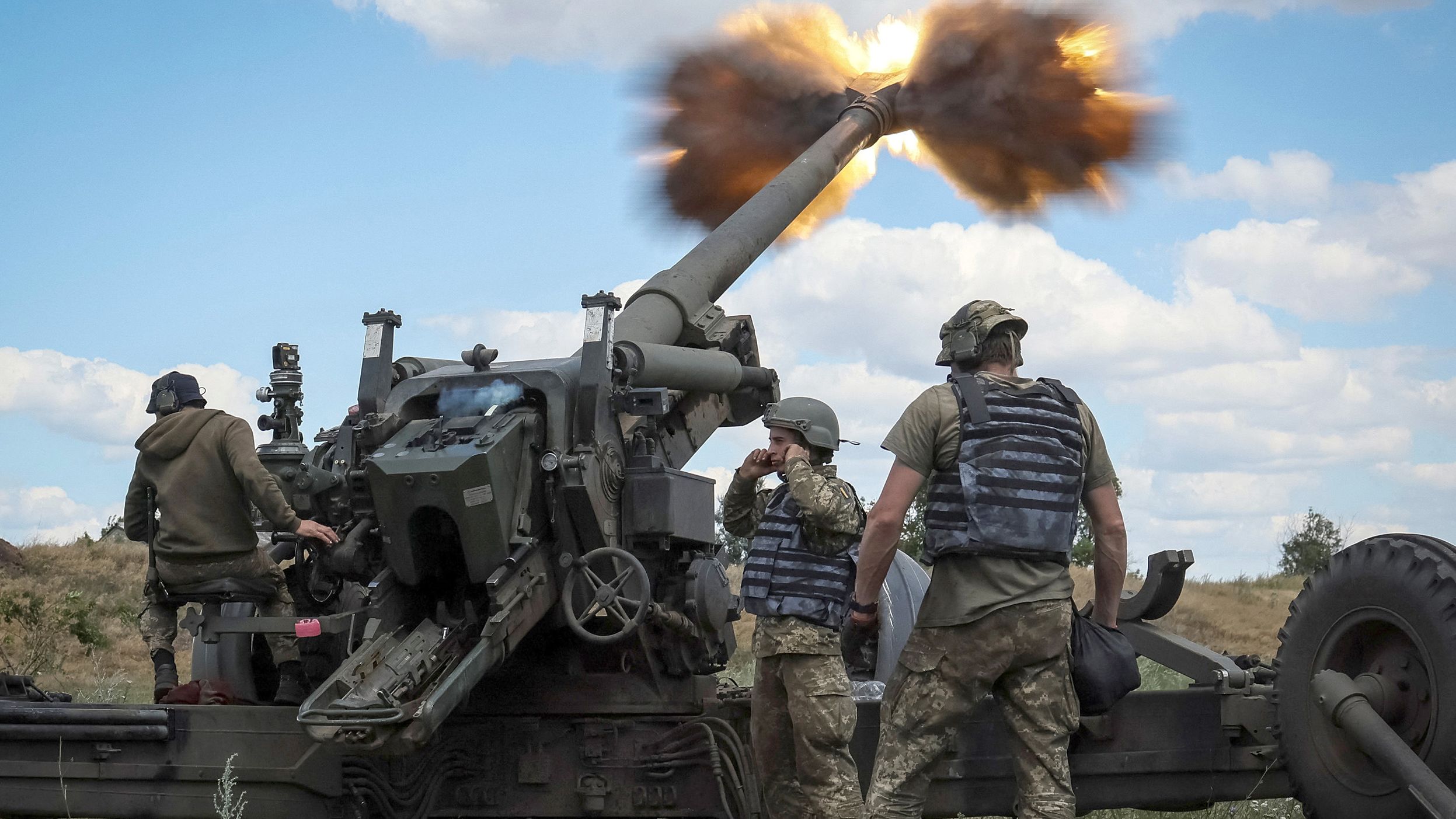 Ukrainian service members fire a shell from a towed howitzer FH-70 at the front line in the Donbas region, Ukraine, on July 18.