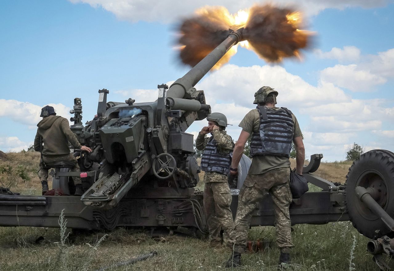Ukrainian service members fire a shell from a towed howitzer FH-70 at the front line in the Donbas region, Ukraine, on July 18.