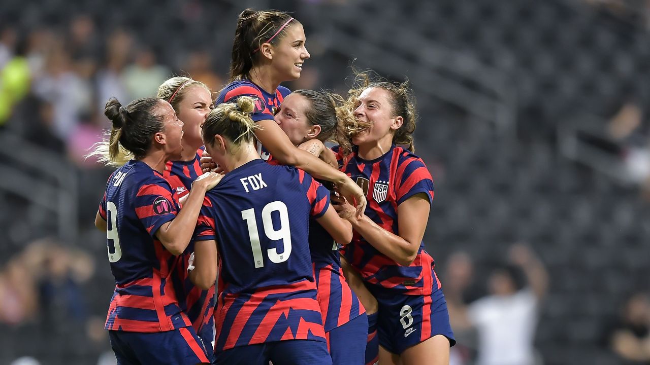 Alex Morgan celebrating with teammates after scoring the 2022 Concacaf W Championship-winning goal.