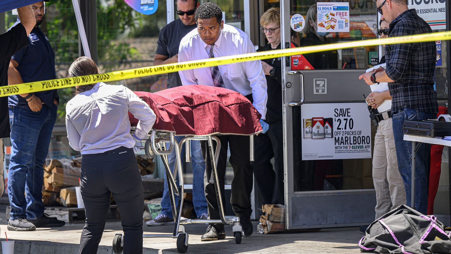 A body is removed from a Brea, California, 7-Eleven after a clerk was fatally shot on July 11.