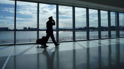 A pilot walks past the windows at the newly renovated Delta terminal D at LaGuardia Airport in New York March 6, 2021.