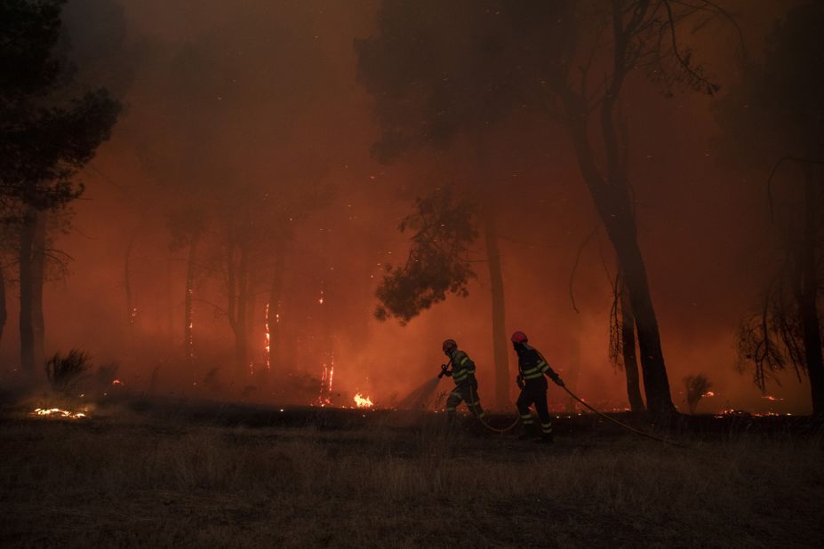 Firefighters work in Avila on July 18.