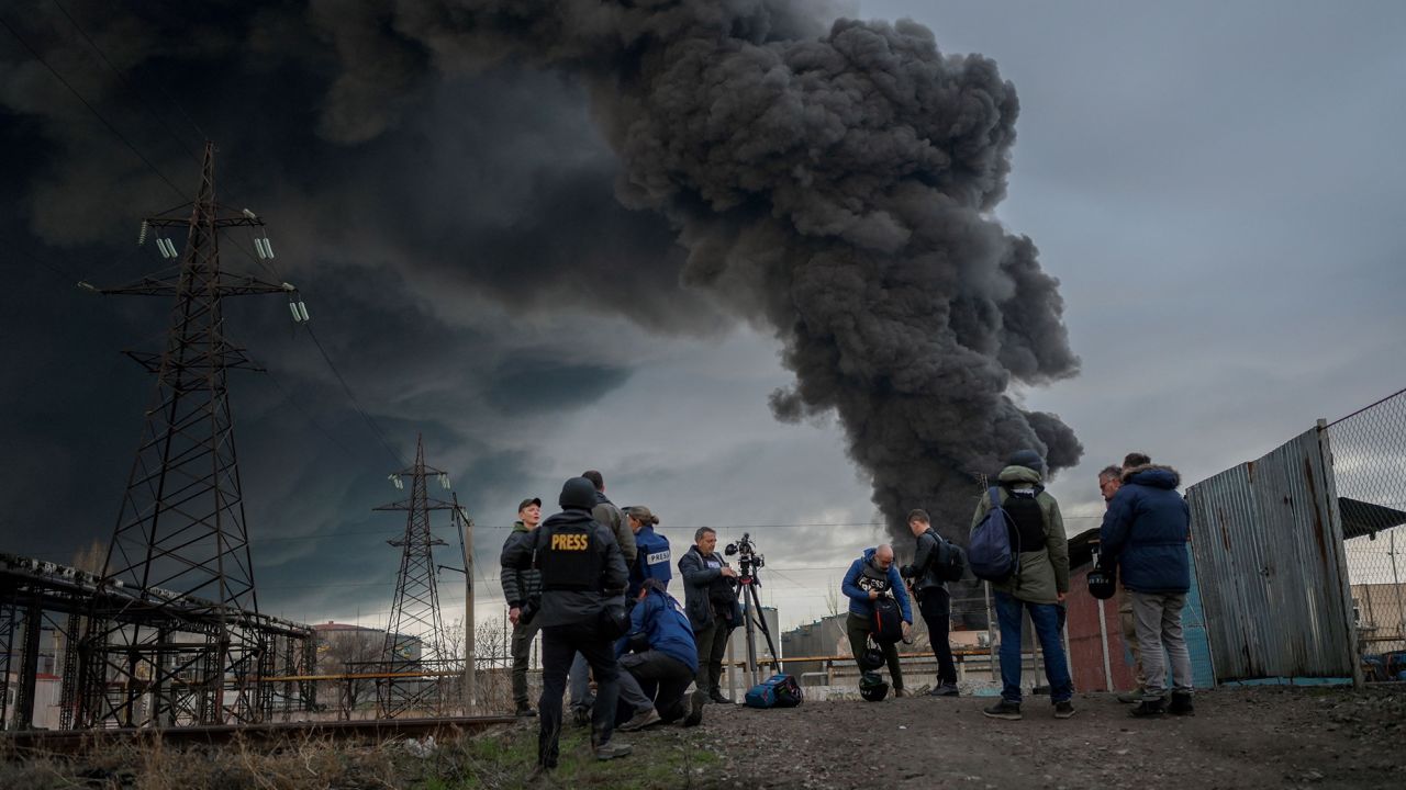 Journalists and residents gather as smoke rises after an attack by Russian forces in Odessa, on April 3.
