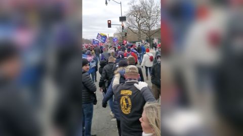 Courtney Holland, right, can be seen walking toward the US Capitol on January 6, 2021, with her hand on the shoulder of an Oath Keeper.