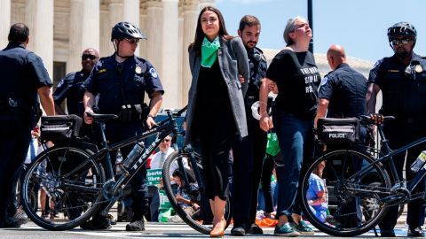 Rep. Alexandria Ocasio-Cortez, D-N.Y., center, is escorted away from a sit-in outside the Supreme Court with members of Congress to protest the decision to overturn Roe v. Wade on Tuesday, July 19, 2022.