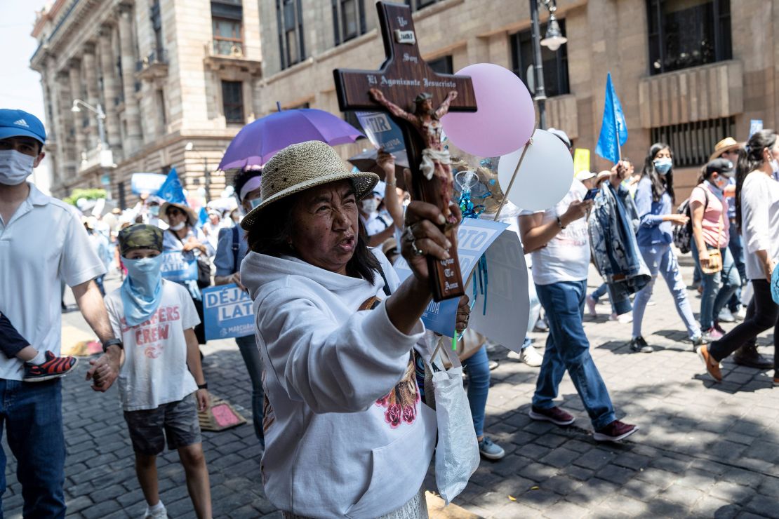 A woman holds a cross as she takes part in an anti-abortion march in Mexico City in May.