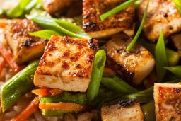 A homemade tofu stir-fry with rice and green vegetables is a crowd pleaser.