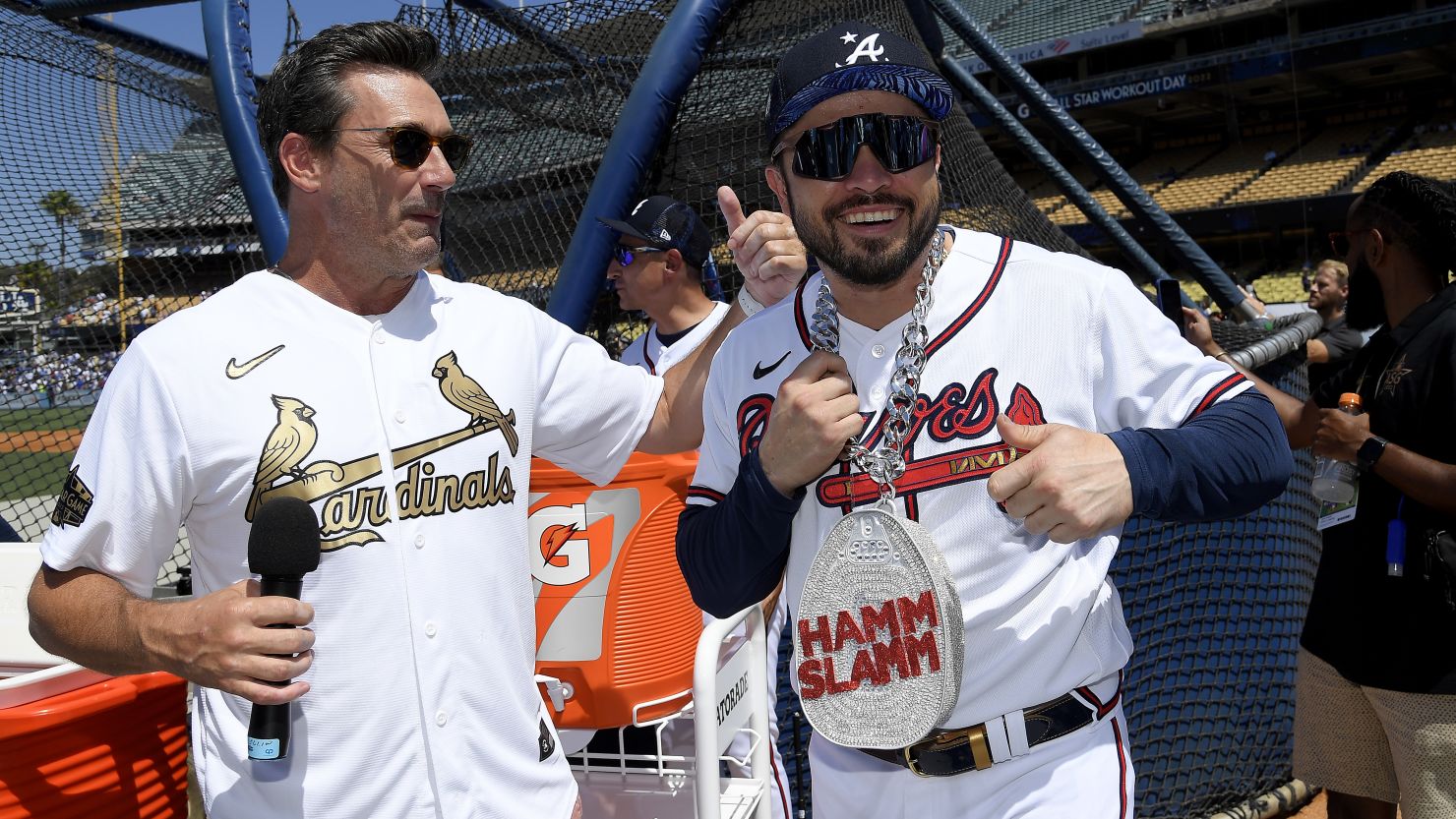 Jon Hamm talks with Travis d'Arnaud of the Atlanta Braves during the 2022 Gatorade All-Star Workout Day at Dodger Stadium on July 18 in Los Angeles. 