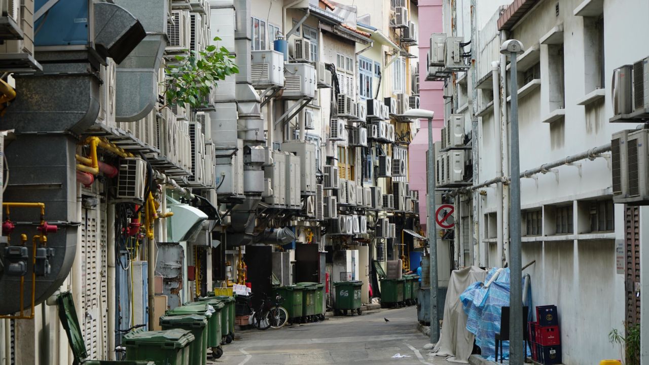 Air conditioning units line a narrow alleyway in central Singapore.