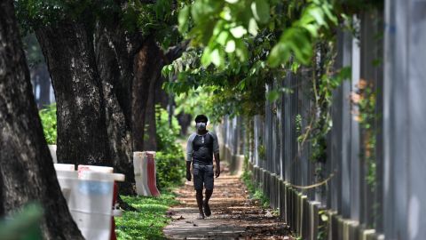 A worker walks by a foreign workers' dormitory in Tuas, Singapore.