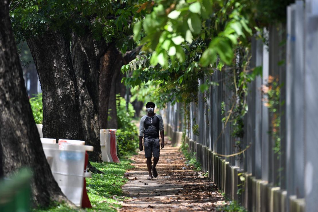 A worker walks by a foreign workers' dormitory in Tuas, Singapore.